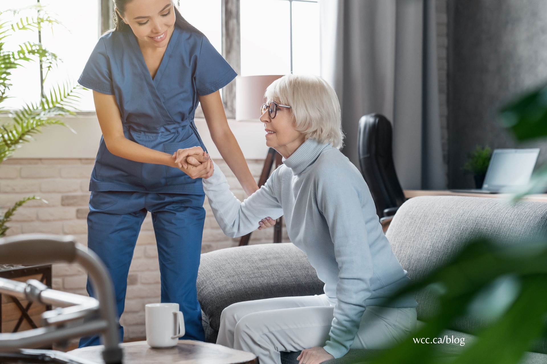A person holding a caregiver's hand while sitting in a comforting environment.